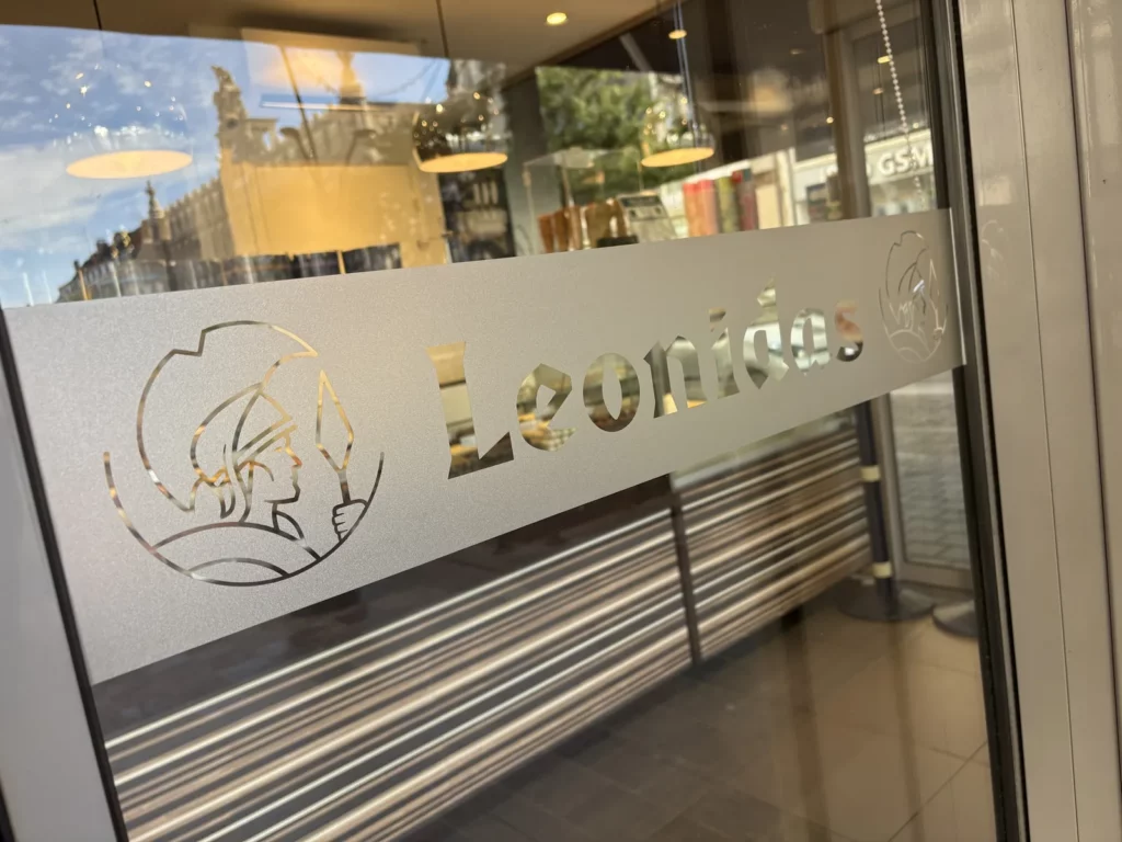 Film dépoli avec logo et lettrage doré sur la vitrine d'un commerce